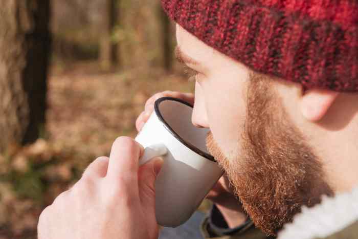 Drinking tea forest handsome bearded standing man navigation post